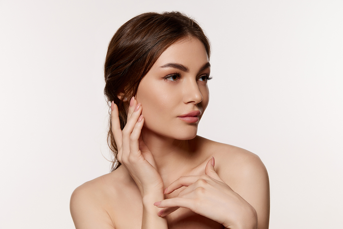 Portrait of young beautiful woman with perfect smooth skin