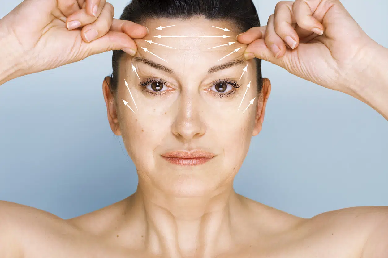 woman pulling on eyebrows woman pulling on eyebrows